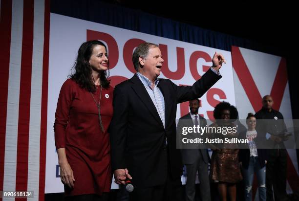 Democratic Senatorial candidate Doug Jones and his wife Louise Jones greet supporters during a get out the vote campaign rally on December 11, 2017...