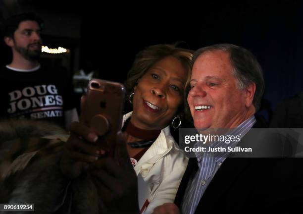 Democratic Senatorial candidate Doug Jones takes a selfie with a supporter during a get out the vote campaign rally on December 11, 2017 in...