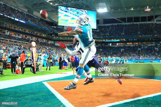 Kenny Stills of the Miami Dolphins fails to make the catch against the New England Patriots during the first quarter at Hard Rock Stadium on December...