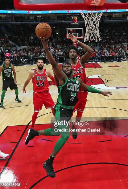 Jaylen Brown of the Boston Celtics goes up for a shot past Justin Holiday of the Chicago Bulls at the United Center on December 11, 2017 in Chicago,...