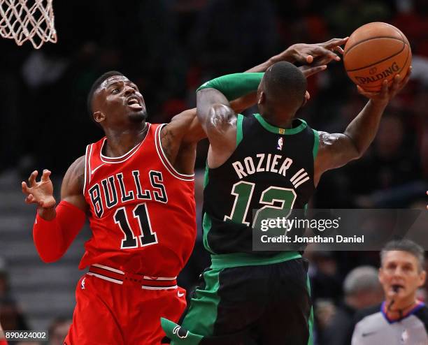 David Nwaba of the Chicago Bulls defends against Terry Rozier of the Boston Celtics at the United Center on December 11, 2017 in Chicago, Illinois....