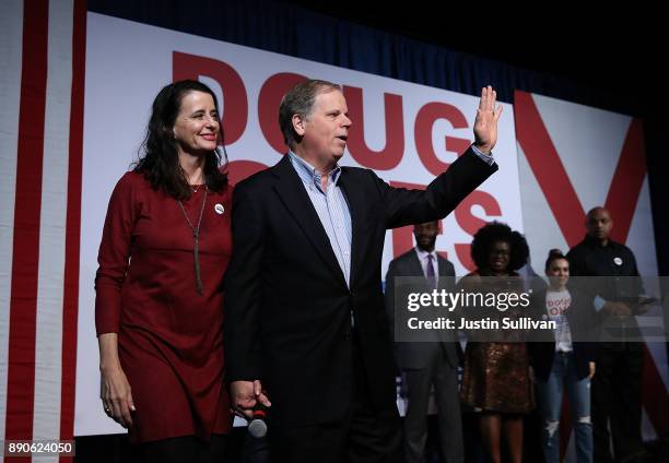 Democratic Senatorial candidate Doug Jones and his wife Louise Jones greet supporters during a get out the vote campaign rally on December 11, 2017...