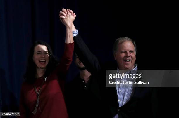 Democratic Senatorial candidate Doug Jones and his wife Louise Jones greet supporters during a get out the vote campaign rally on December 11, 2017...