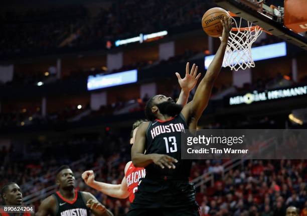James Harden of the Houston Rockets shoots a layup in the first half defended by Omer Asik of the New Orleans Pelicans at Toyota Center on December...