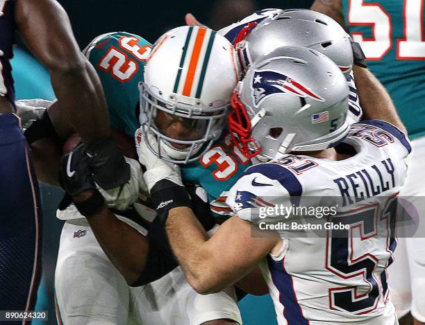 New England Patriots middle linebacker Trevor Reilly wraps up Miami Dolphins running back Kenyan Drake during the first quarter of a game at the Hard...