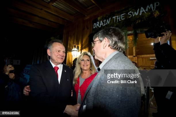 Republican Senate candidate Roy Moore, left, and his wife Kayla leave Moore's "Drain the Swamp" rally in Midland City, Ala., on Monday, Dec. 11, 2017.
