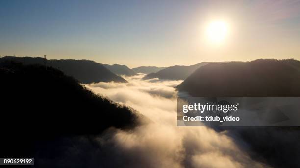 sun rises above the clouds in japan deep in the mountains - tdub_video stock pictures, royalty-free photos & images