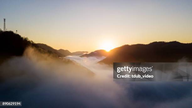 the sun rises above the clouds in the mountains of japan - tdub_video stock pictures, royalty-free photos & images