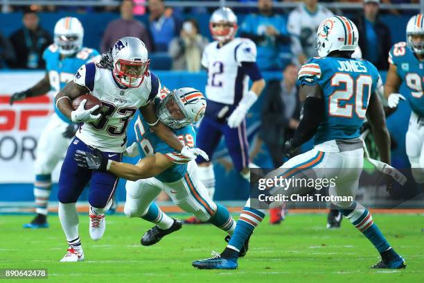 Dion Lewis of the New England Patriots tries to avoid the tackle from Chase Allen of the Miami Dolphins during the second quarter at Hard Rock...