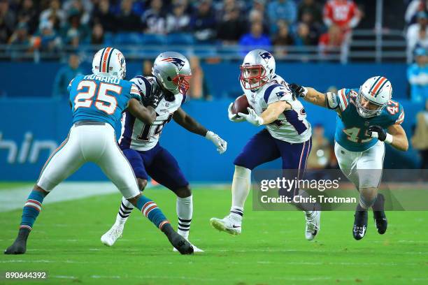 Rex Burkhead of the New England Patriots rushes during the second quarter against the New England Patriots at Hard Rock Stadium on December 11, 2017...