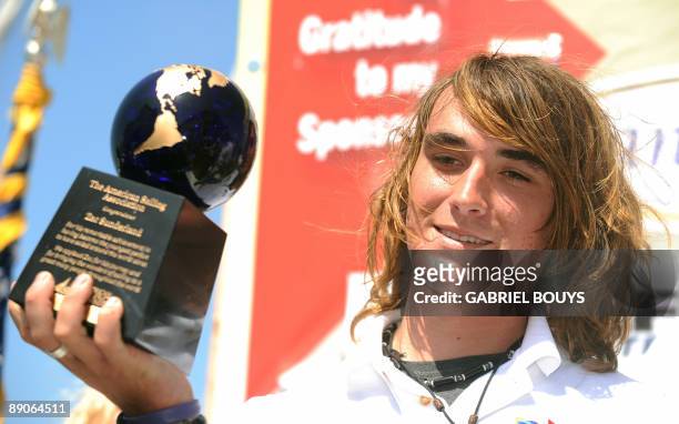 Zac Sunderland holds a trophy after he arrived at Marina Del Rey, California, on July 16, 2009. The 17-year-old teenager became the youngest person...