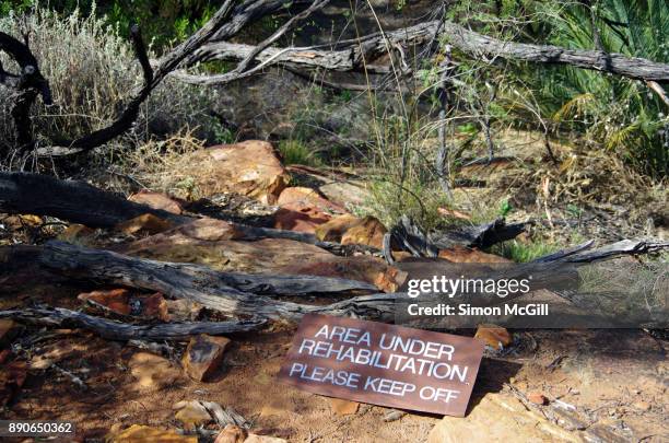 'area under rehabilitation - please keep off' sign in the garden of eden on the route of the kings canyon rim walk, watarrka national park, northern territory, australia - keep off the grass sign stock pictures, royalty-free photos & images