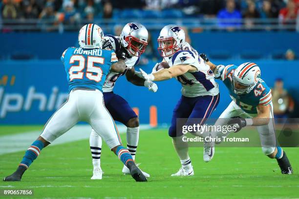 Rex Burkhead of the New England Patriots rushes during the second quarter against the New England Patriots at Hard Rock Stadium on December 11, 2017...