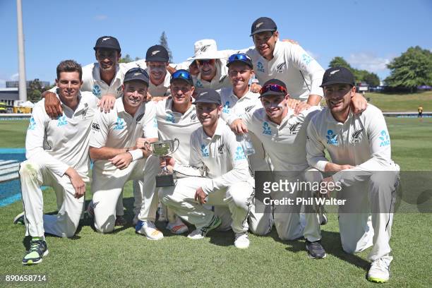 The New Zealand Black Caps pose with the ANZ Series Trophy during day four of the Second Test Match between New Zealand and the West Indies at Seddon...