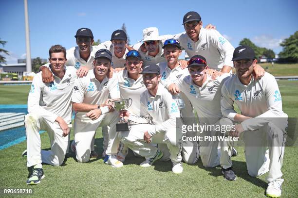 The New Zealand Black Caps pose with the ANZ Series Trophy during day four of the Second Test Match between New Zealand and the West Indies at Seddon...