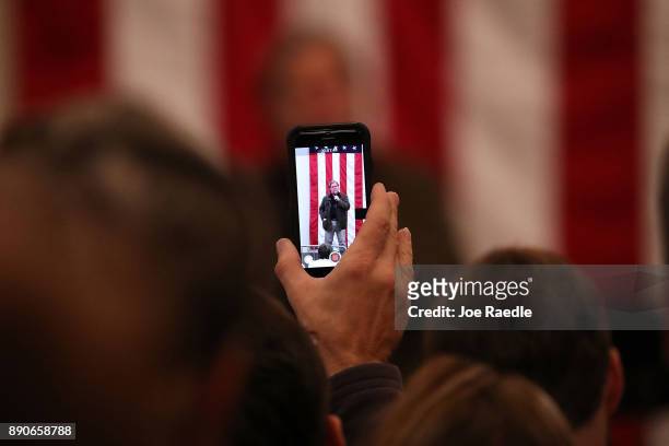Steve Bannon is seen on the screen of an iPhone as he speaks before the arrival of Republican Senatorial candidate Roy Moore during a campaign event...