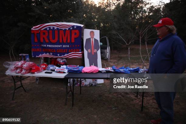 Whitey Taylor sells President Donald Trump items as people arrive to hear Republican Senatorial candidate Roy Moore speak during a campaign event at...