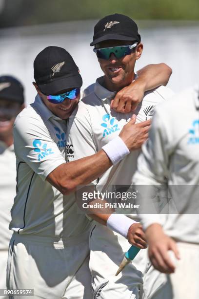 Trent Boult and Neil Wagner of the New Zealand Black Caps celebrate following day four of the Second Test Match between New Zealand and the West...
