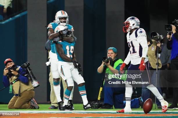 Jakeem Grant of the Miami Dolphins celebrates his third quarter touchdown against the New England Patriots at Hard Rock Stadium on December 11, 2017...