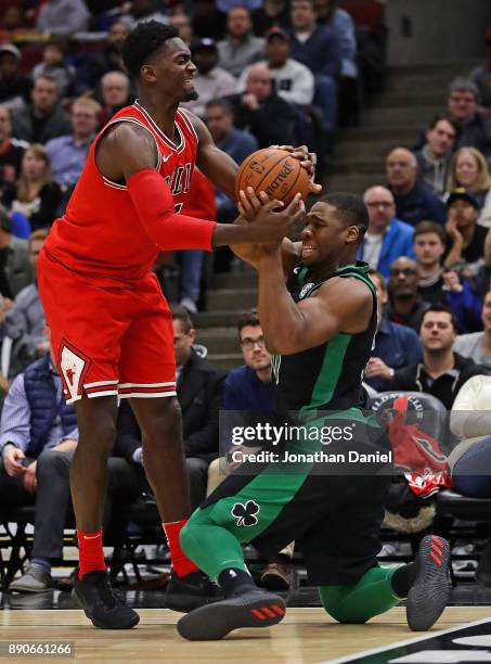 Bobby Portis of the Chicago Bulls and Guerschon Yabusele of the Boston Celtics battle for the ball at the United Center on December 11, 2017 in...