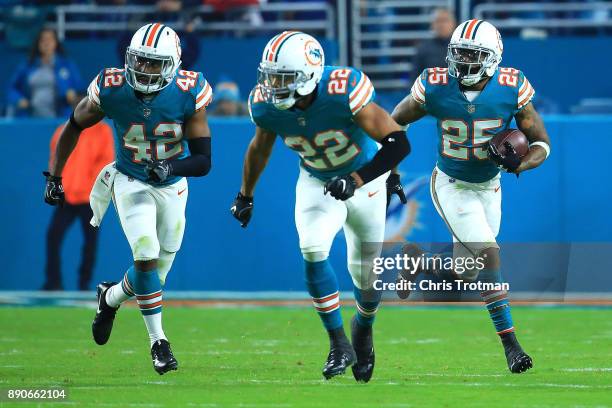 Walt Aikens of the Miami Dolphins carries the ball during the third quarter against the New England Patriots at Hard Rock Stadium on December 11,...