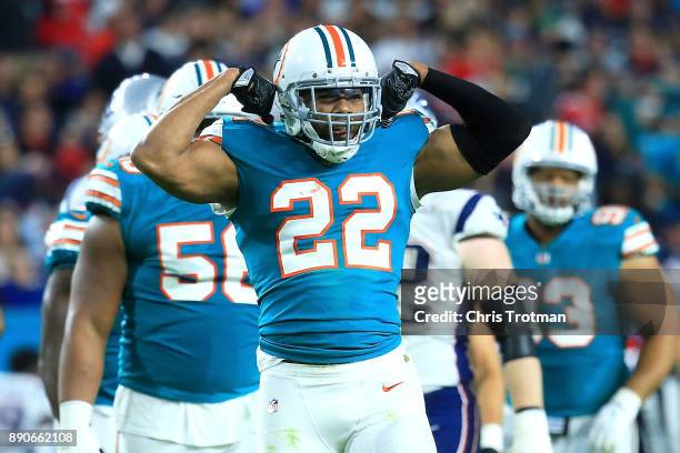 McDonald of the Miami Dolphins celebrates after a stop on Dion Lewis of the New England Patriots during the third quarter at Hard Rock Stadium on...