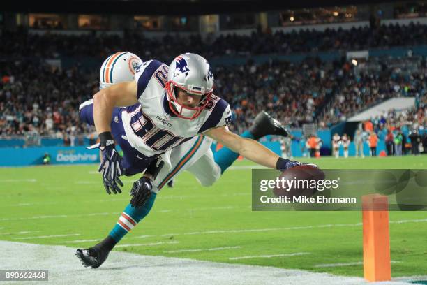 Danny Amendola of the New England Patriots fails to complete a touchdown against the defense of T.J. McDonald of the Miami Dolphins in the fourth...