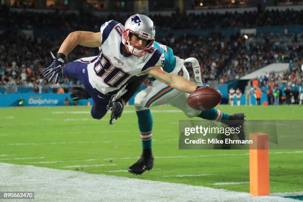 Danny Amendola of the New England Patriots fails to complete a touchdown against the defense of T.J. McDonald of the Miami Dolphins in the fourth...