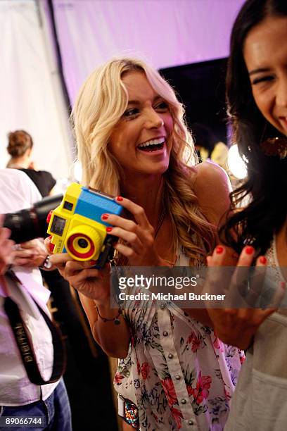 Models take photos backstage at the Caffe Swimwear 2010 fashion show during Mercedes-Benz Fashion Week Swim at Beachway at The Raleigh on July 16,...