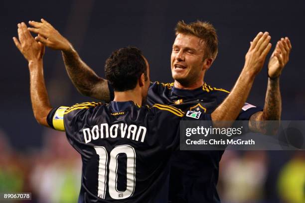 Landon Donovan and David Beckham of the LA Galaxy celebrate a goal in the first half by teammate Eddie Lewis during the game against the New York Red...