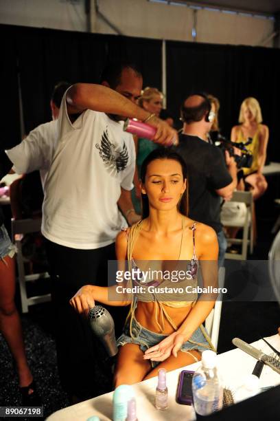 Model prepares backstage at the Tibi 2010 fashion show during Mercedes-Benz Fashion Week Swim at Cabana Grande at The Raleigh on July 16, 2009 in...