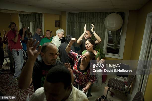 Activists rehearse for their protest in a church space on July 08, 2009 in Washington, DC. The activists plan on chaining themselves together in the...