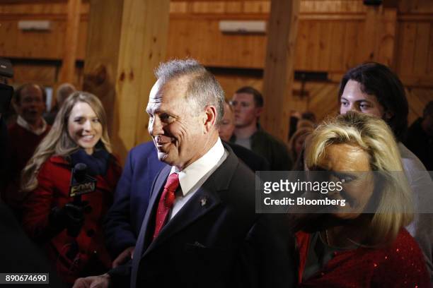 Roy Moore, Republican candidate for U.S. Senate from Alabama, center, and his wife Kayla Moore, right, leave a campaign rally in Midland City,...