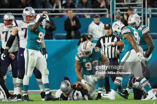 Charles Harris Cameron Wake and Ndamukong Suh of the Miami Dolphins celebrate sacking Tom Brady of the New England Patriots in the fourth quarter at...