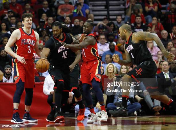 Nene Hilario of the Houston Rockets battles with Jrue Holiday of the New Orleans Pelicans for a loose ball in the second half at Toyota Center on...