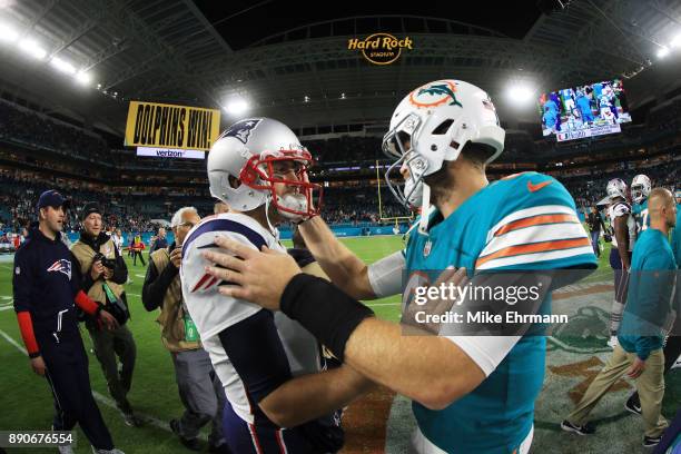 Brian Hoyer of the New England Patriots congratulates Jay Cutler of the Miami Dolphins on their 27 to 20 win at Hard Rock Stadium on December 11,...