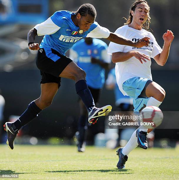 Inter Milan midfielder Joel Obi from Nigeria kicks the ball in front of UCLA defender Anthony Avalos during a practice game against UCLA in Westwood,...