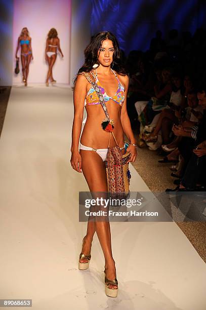 Model walks the runway at the Caffe Swimwear 2010 fashion show during Mercedes-Benz Fashion Week Swim at the Beachway at The Raleigh on July 16, 2009...