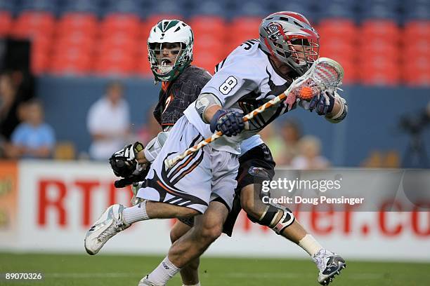 Greg Downing of the Young Guns battles past the defense of Stephen Berger of Stephen Berger during the 2009 Major League Lacrosse All Star Game at...