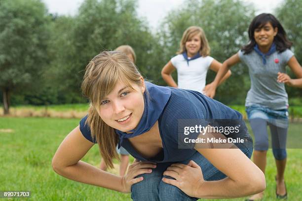 scoutng girls playing leap-frog - bockspringen stock-fotos und bilder