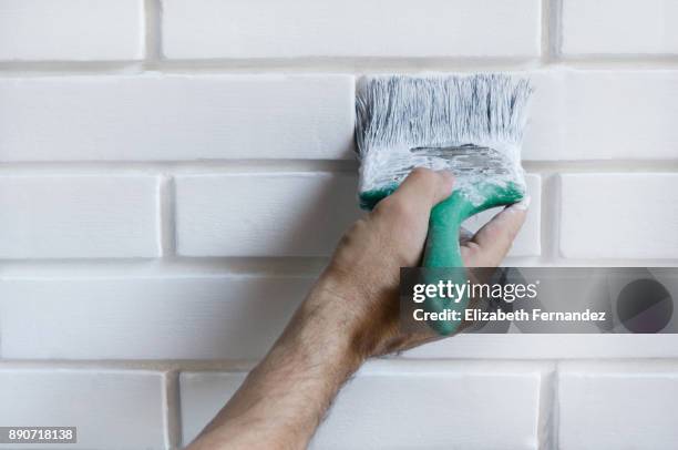 man painting with brush brick wall on white color - brick wall close up stock pictures, royalty-free photos & images