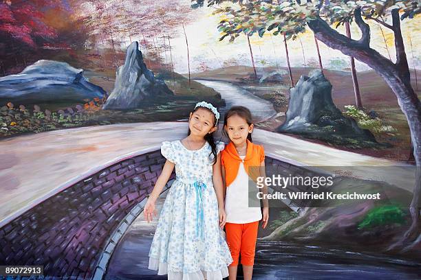 2 girls in front of traditional  wall painting - phu yen province stock pictures, royalty-free photos & images