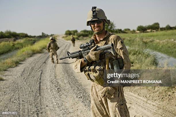 Marine Staff Sergeant. David S. Spicer of 1st Combat Engineering Battalion of 2nd Marine Expeditionary Brigade looks back as mine sweepers scan the...