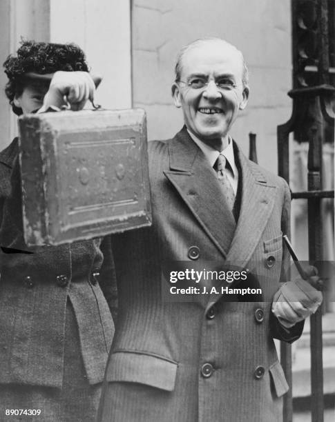 British Chancellor of the Exchequer Sir Stafford Cripps holds up his dispatch box, before leaving 11 Downing Street to give his budget speech to the...