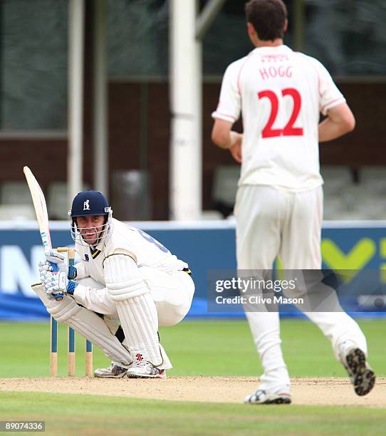 Rikki Clarke of Warwichshire smiles as he avoids a delivery from Kyle Hogg of Lancashire during Day 3 of the LV County Championship Division One...