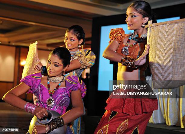 Sri Lankan dancers perform during an event to promote their country's tourism industry in Bangalore on July 17, 2009. The tourism event was organised...