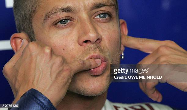 Italian Yamaha driver Valentino Rossi gestures in his box on the sidelines of the MotoGP race training of the German Grand Prix meeting on July 17,...