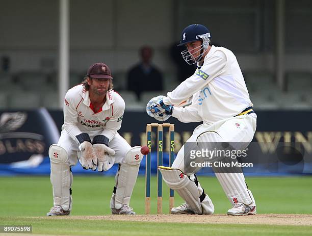 Rikki Clarke of Warwichshire hits a delivery as Luke Sutton of Lancashire keeps wicket during Day 3 of the LV County Championship Division One match...