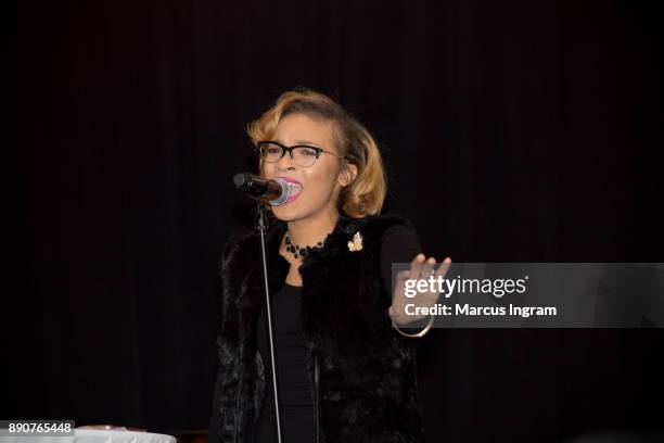 Singer Sharon Moore performs onstage during the '5th Annual Caroling with Q Parker and Friends' at Atlanta Marriott Buckhead on December 11, 2017 in...