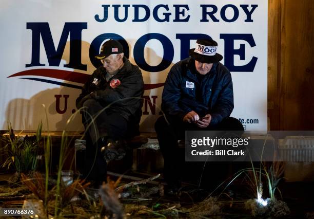 Judge Roy Moore supporters sit outside listening to comments made during the "Drain the Swamp" Roy Moore campaign rally in Midland City, Ala., on...
